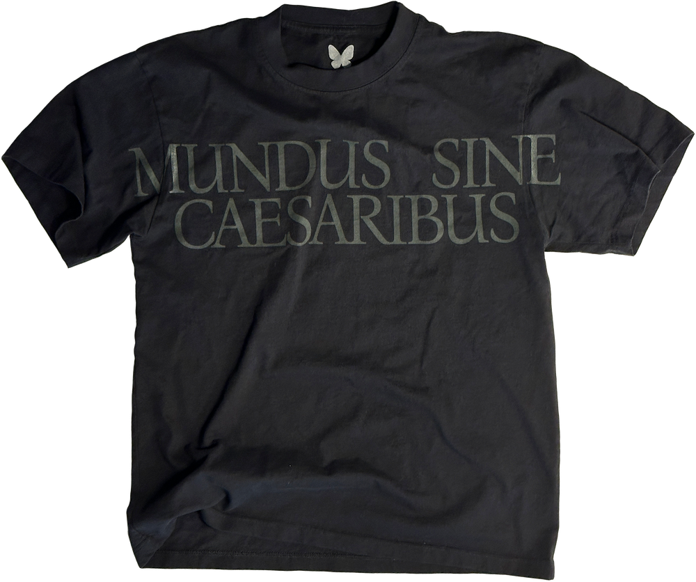 Image of oversized black cotton shirt with dark text across chest that reads 'MUNDUS SINE CAESARIBUS'. In English, 'A WORLD WITHOUT CAESARS'.